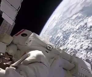 کارکردن فضانوردان در خارج از ایستگاه بین‌المللی فضایی و پس زمینه‌ای از سیاره مادری 